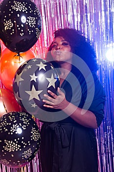 Beautiful black woman enjoying a party lifestyle. Birthday party, clubbing and holidays concept.