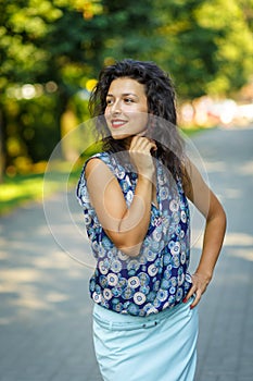 Beautiful blackhaired model girl posing for cloth and bags promotion at city streets background
