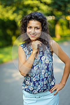 Beautiful blackhaired model girl posing for cloth and bags promotion at city streets background