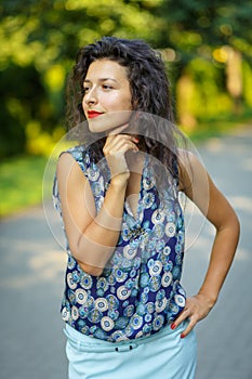 Beautiful blackhaired model girl posing for cloth and bags promotion at city streets background