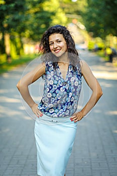 Beautiful blackhaired model girl posing for cloth and bags promotion at city streets background