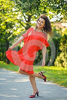 Beautiful blackhaired model girl posing for cloth and bags promotion at city streets background