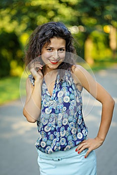 Beautiful blackhaired model girl posing for cloth and bags promotion at city streets background