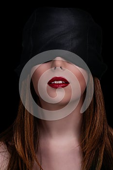 Beautiful blindfolded woman with red lipstick