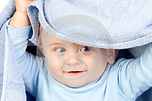 Beautiful blond baby with a towel