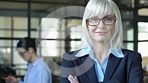 Beautiful blond businesswoman smiling on camera, trustworthy bank officer