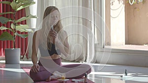 Beautiful blond caucasian young woman is making meditation with sage smudge sticks. Video footage still shot portrait.