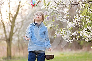 Beautiful blond child, boy, holding twig, braided whip made from pussy willow, traditional symbol of Czech Easter used for