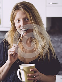 Beautiful blond enjoying coffee at home