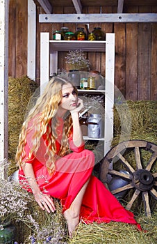 Beautiful blond fashionable woman on hay barn