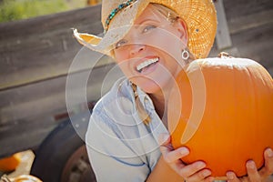 Beautiful Blond Female Rancher Wearing Cowboy Hat photo