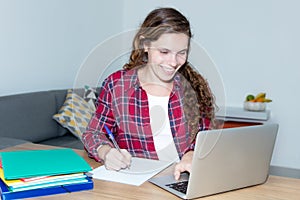 Beautiful blond female student working with computer