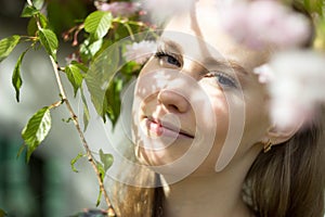 Beautiful blond girl in blossom garden