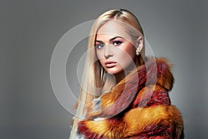 Beautiful Blond Girl in colorful Fur