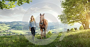 Beautiful blond girl with a horse in wonderful landscapes