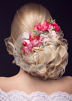 Beautiful blond girl in image of the bride with purple flowers on her head. Beauty face. Hairstyle back view