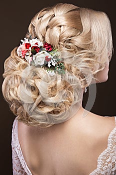 Beautiful blond girl in image of the bride with purple flowers on her head. Beauty face. Hairstyle back view