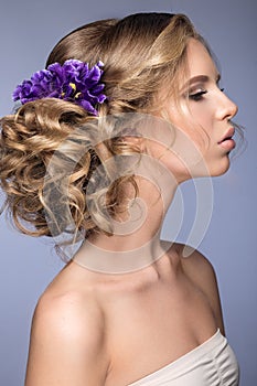 Beautiful blond girl in image of the bride with purple flowers on her head. Beauty face.