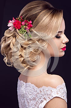 Beautiful blond girl in image of the bride with purple flowers on her head. Beauty face