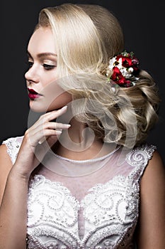 Beautiful blond girl in image of the bride with purple flowers on her head. Beauty face.