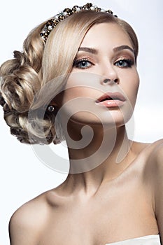 Beautiful blond girl in the image of a bride with a tiara in her hair. Beauty face. Wedding image.