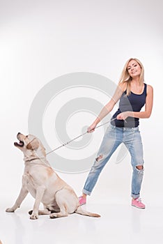 Beautiful blond girl with Labrador Retriever