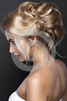 Beautiful blond girl with perfect skin, evening make-up, wedding hairstyle. Beauty face.