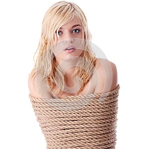 The beautiful blond girl tied with rope