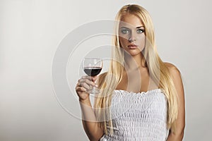 Beautiful blond girl with wineglass.dry red wine.sexy young woman with alcohol. your text here