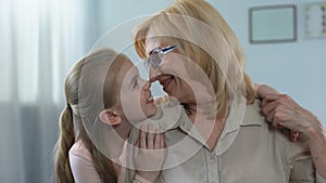 Beautiful blond granddaughter hugging her grandmother with love, care, support