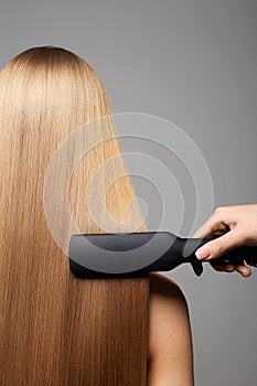 beautiful blond hair woman. Back of girl. Care and straightening hair