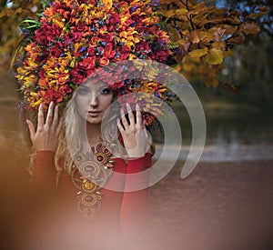 Beautiful blond nymph wearing impressive, colorful coronet photo