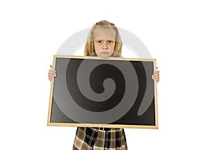 Beautiful blond schoolgirl sad moody and tired holding and showing small blank blackboard