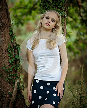 Beautiful Blond Teenage Girl Outside In The Woods