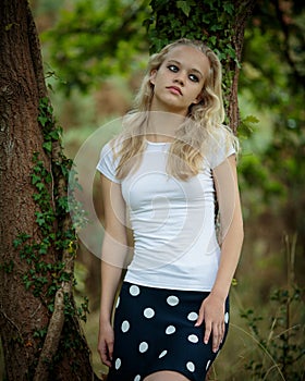 Beautiful Blond Teenage Girl Outside In The Woods
