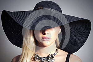 Beautiful Blond Woman in Black Hat.Jewelry