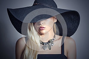 Beautiful Blond Woman in Black Hat.Lady in Jewelry