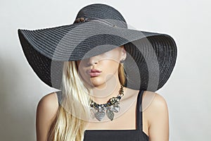 Beautiful Blond Woman in Black Hat.spring shopping
