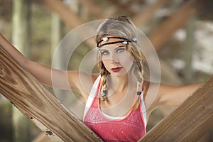 A beautiful blond woman with braids under pier in St.Augustine, Florida.