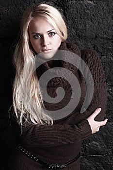 Beautiful blond woman in brown sweater