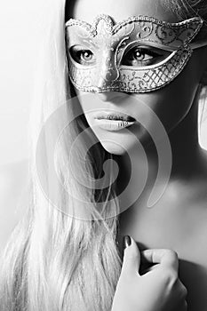 Beautiful Blond Woman in Carnival Mask.Masquerade. Girl. Beauty & Fashion