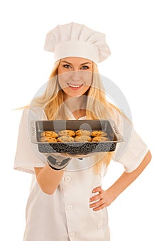 Beautiful blond woman in chef dress bakes cookies isolated over