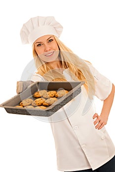 Beautiful blond woman in chef dress bakes cookies isolated over