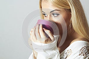 Beautiful blond woman drinking Coffee. Vapor Cup of tea