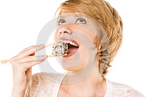 Beautiful blond woman eating sushi. studio