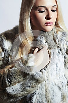 Beautiful blond woman in fur.winter fashion.Beauty blond Model Girl in Rabbit Fur