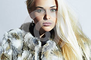 Beautiful blond woman in fur.winter fashion portrait.Beauty blond Girl in Rabbit Fur Coat