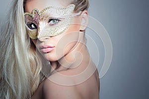 Beautiful Blond Woman in a Golden Mask.Masquerade. Girl