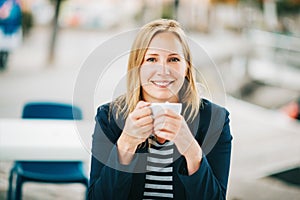 Beautiful blond woman having a break with cup of coffee