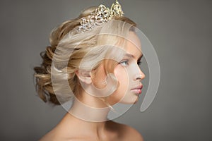 Beautiful blond woman in the image of a bride with a tiara in her hair